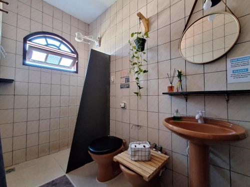 a bathroom with a sink and a toilet at Odoyá Casa Hostel in Arraial d'Ajuda