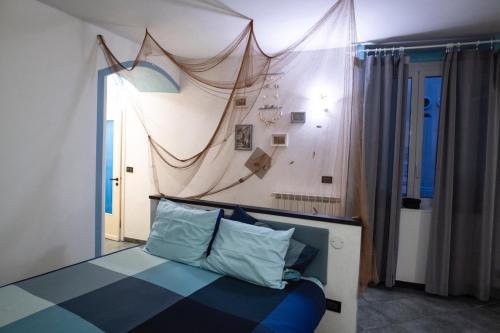 a bedroom with a bed with a surfboard on the wall at Cogo House in Cogoleto