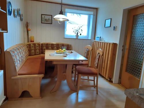 a living room with a table and a couch at Haus Dreier in Abtenau