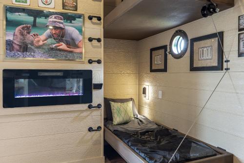 a man with a dog in a room with a tv at "The 19th Hole" Luxury Treehouse w Golf Views & Private 20ft Slide - 10 Miles from Dollywood in Catlettsburg