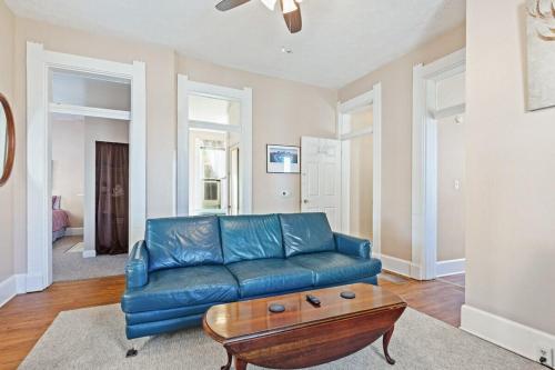 a living room with a blue couch and a coffee table at Big Yellow in Indianapolis