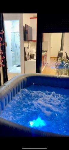 a large tub filled with blue water in a living room at Apartment Jacuzzi Mostar in Mostar