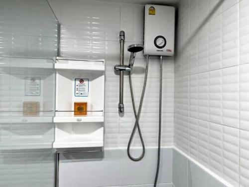 a shower in a bathroom with a shower head at Sukhumvit soi 4 Apartment Center of BKK in Bangkok
