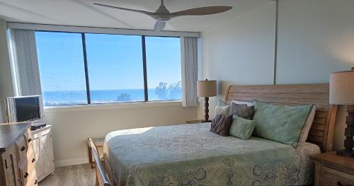 a bedroom with a bed and a ceiling fan at Our House at the Beach W-704 in Siesta Key