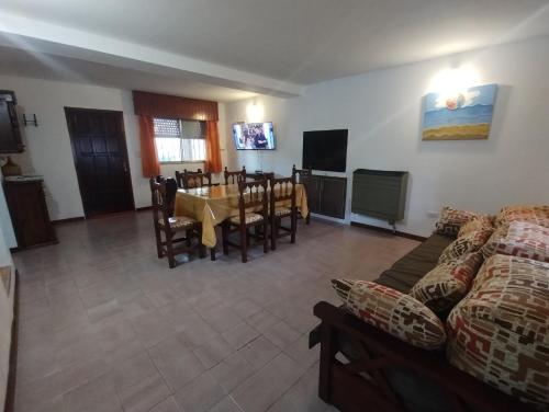 a living room with a table and a dining room at CASA AGUAS AZULES 6 pax LAS GRUTAS in Las Grutas