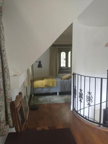 a staircase leading to a bedroom with a bed at Quirky, romantic cottage with garden in Wye Valley in Ross on Wye