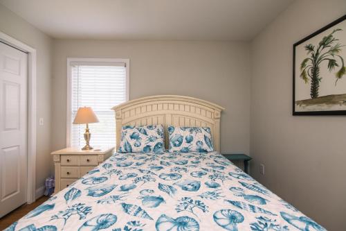 a bedroom with a bed with a blue and white bedspread at Grand View in Edisto Island