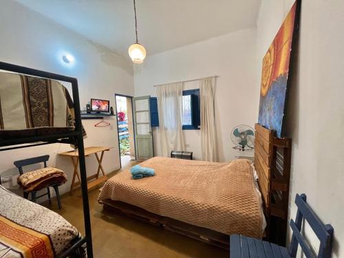 a bedroom with a bed and a table and a desk at Renacer en Salta in Salta