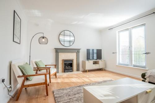 a living room with a table and a fireplace at 50 Sansome Place in Worcester