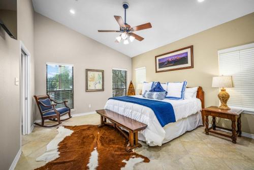 a bedroom with a bed and a ceiling fan at Waterfront Dock Fire Pit Book for Wurstfest Family in McQueeney