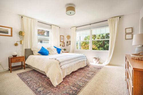 ビーバートンにあるSpruce White Houseのベッドと大きな窓のある寝室