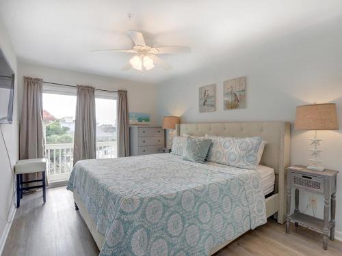 a bedroom with a bed and a ceiling fan at Sweet Location with Sophistication in Tybee Island