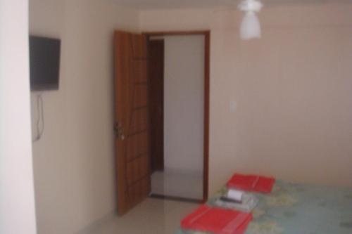 a room with a door and a room with red boxes at stellamares apartamentos in Salvador