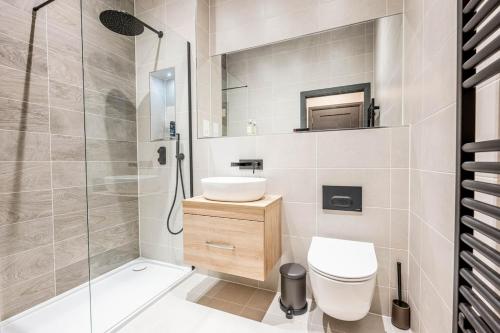 a bathroom with a shower and a toilet and a sink at Stylish Studio Apartment in Southampton