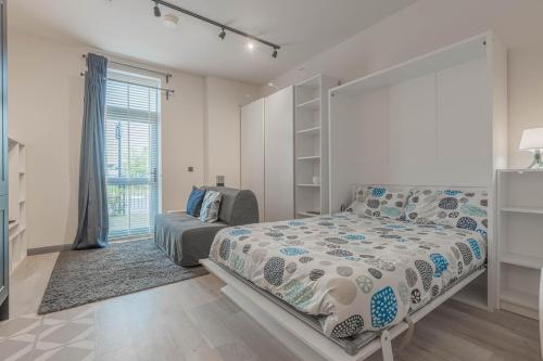 a bedroom with a bed and a large window at Stylish Studio Apartment in Southampton