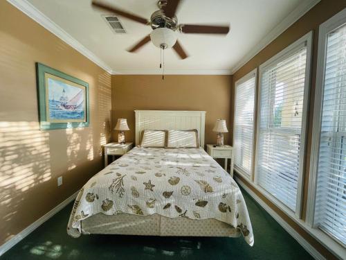 a bedroom with a bed and a ceiling fan at 123 Beau Clair - Beachside Townhome with Balcony and Pool in Long Beach in Long Beach