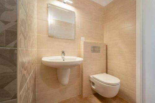 a bathroom with a sink and a toilet and a mirror at Mountain View 2 Bedroom Chalet in Alcobaça