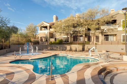 a swimming pool in front of a house at Raintree at Phoenix South Mountain Preserve in Phoenix
