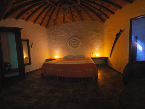 a bedroom with a large bed in a room at Cabañas el Nido de la Huilota in Tepoztlán