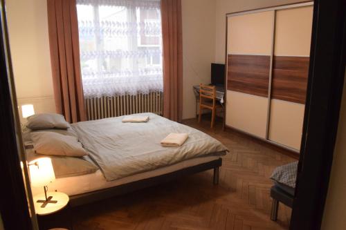 a small bedroom with a bed and a window at DáMa in Ružomberok