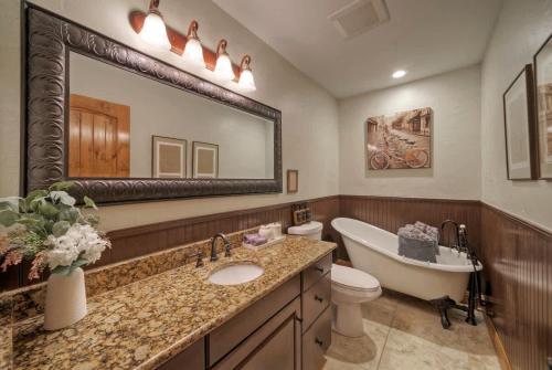 a bathroom with a tub and a toilet and a sink at Waterfront Sleeps 16 Perfect for Family & Wurstfest in McQueeney