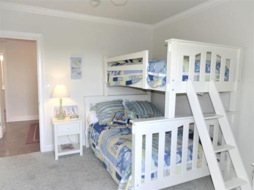 a bedroom with two bunk beds and a bed at Gulf and Bay Club- F401 in Siesta Key