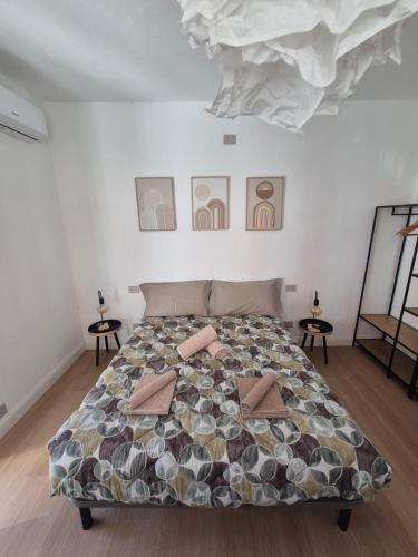 a bedroom with a large bed with pillows on it at Il Glicine Bianco in Omegna