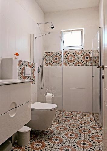 a bathroom with a shower and a toilet and a sink at בדרך לנחל הבניאס in Sde Nehemia