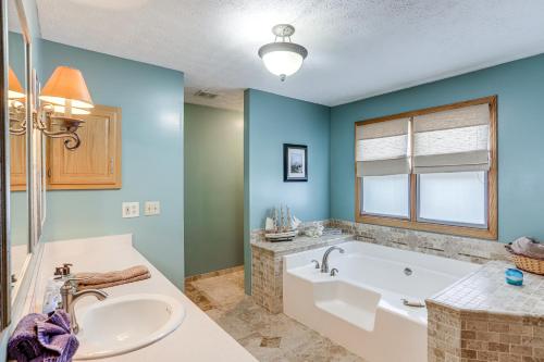 a bathroom with a tub and a sink at Work and Relax! Spacious Ontario Home with Pool in Mansfield