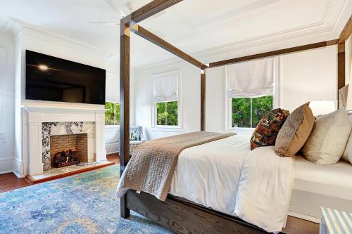 a bedroom with a bed and a fireplace at 3 W Perry St in Savannah