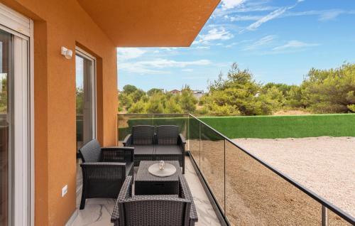 a balcony with chairs and a table and a view at Nice Apartment In Vir With Heated Swimming Pool in Pedinka