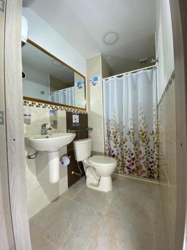 a bathroom with a toilet and a sink and a shower at Casa Borbon in Salento