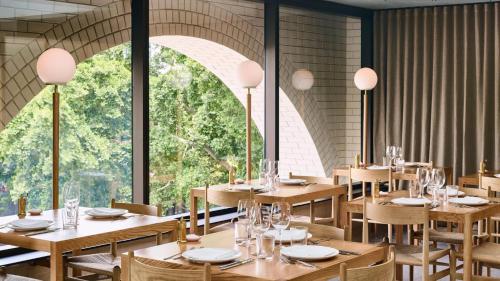 a restaurant with wooden tables and chairs and a large window at Prime Located Luxe 2 BR Sky Home/Sensational Views in Brisbane