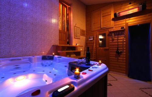 a bathroom with a jacuzzi tub with candles in it at Pet Friendly Home In Gornje Dubrave With Sauna in Perići