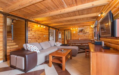 a living room with a couch and a table at Pet Friendly Home In Gornje Dubrave With Sauna in Perići