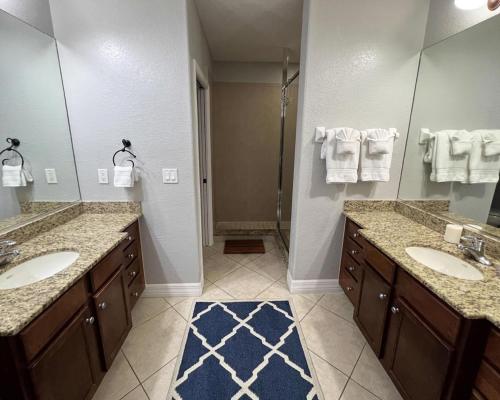 a bathroom with two sinks and a large mirror at Manasota Key Gem - Pool and Hot Tub - Beach Views in Punta Gorda Beach