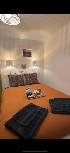 a bedroom with a bed with black towels on it at Parenthèse nantaise, T2 chic et cosy, magie de Noël incluse, avec parking in Nantes