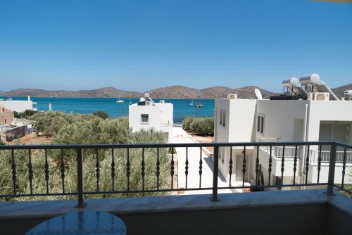a view of the ocean from the balcony of a house at Elounda Sea Suites in Elounda