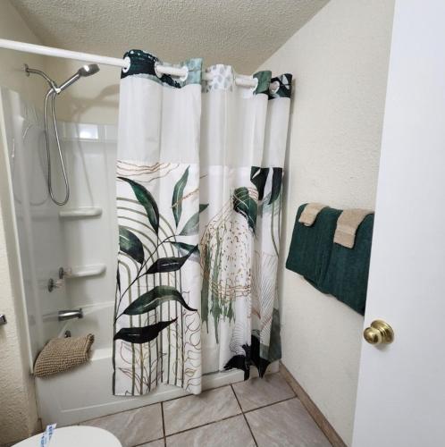 a bathroom with a shower curtain with a bird at The Getaway -6 miles from SNP in Three Rivers