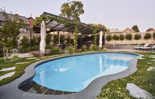 a swimming pool in the yard of a house at Belgravia Residence Rooftop Pool Oasis in Bendigo