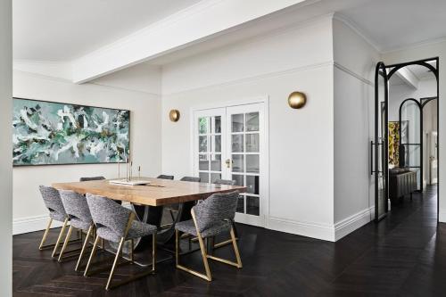 a dining room with a wooden table and chairs at Belgravia Residence Rooftop Pool Oasis in Bendigo