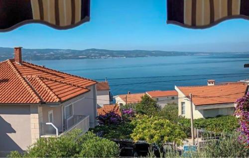 a view of a city with houses and the water at Cozy Apartment In Omis With House Sea View in Tice