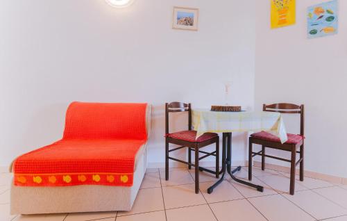 a room with a table and two chairs and a table and stool at Cozy Apartment In Omis With House Sea View in Tice