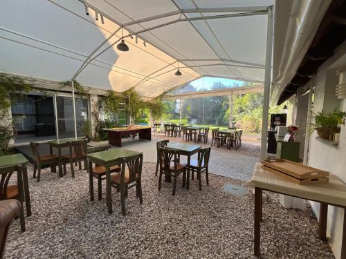 a patio with tables and chairs under a tent at Arsamici Hotel in Punta del Este