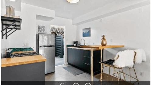 a kitchen with a stainless steel refrigerator and a counter at The Marley by AvantStay in Palm Springs