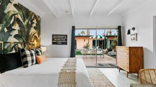 a bedroom with a large bed and a patio at The Marley by AvantStay in Palm Springs