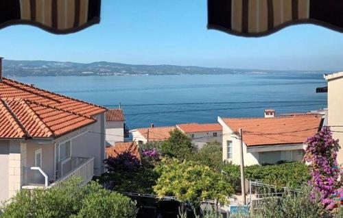 a view of a city with houses and the water at Lovely Apartment In Omis With Wifi in Tice