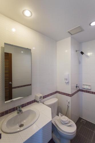 a bathroom with a sink and a toilet and a mirror at Riverside Hotel in Krabi town