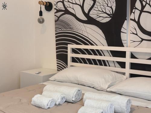 a bedroom with a bed with towels on it at Nido Madreperla in Taranto