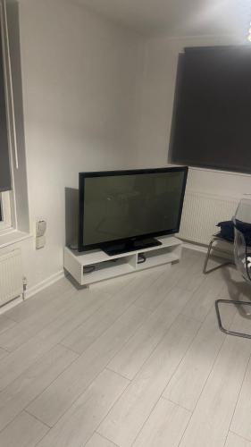 a flat screen tv sitting in a living room at Modern 1-Bed Flat in Crystal Palace Sydenham in Sydenham